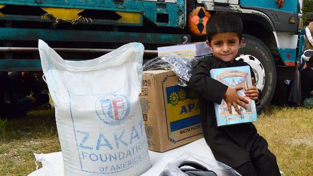 Child sitting on Zakat Foundation provided relief package