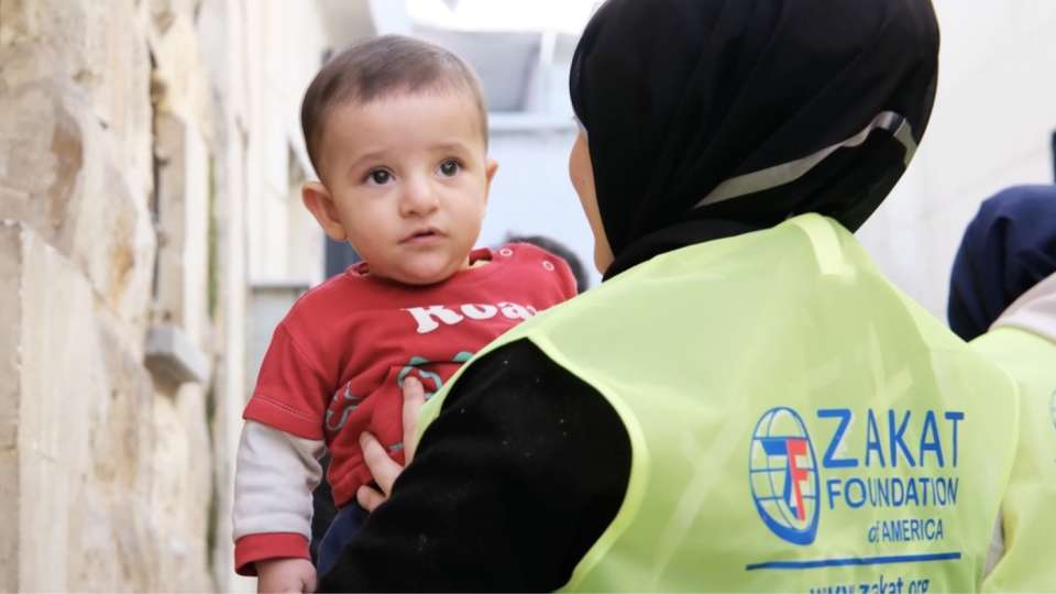 A child in Turkiye is comforted by a ZFA rep
