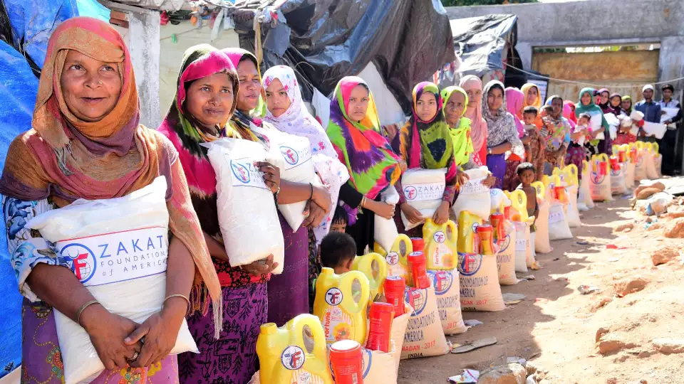 Women holding Zakat donations.