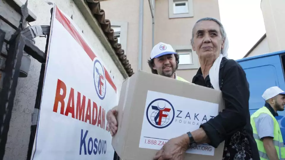Donations being handed to a woman in Kosovo.