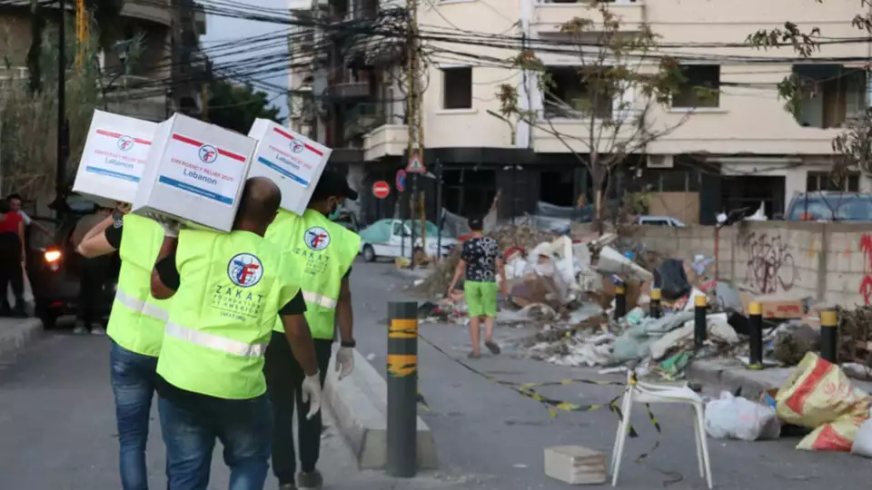 Zakat workers carrying boxes