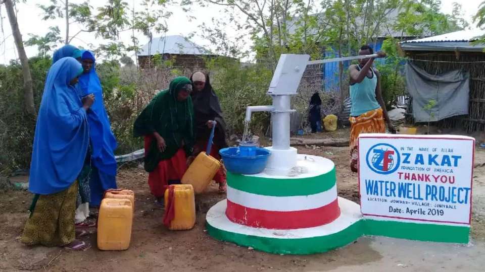 Somalis gathering water from a Zakat water well.