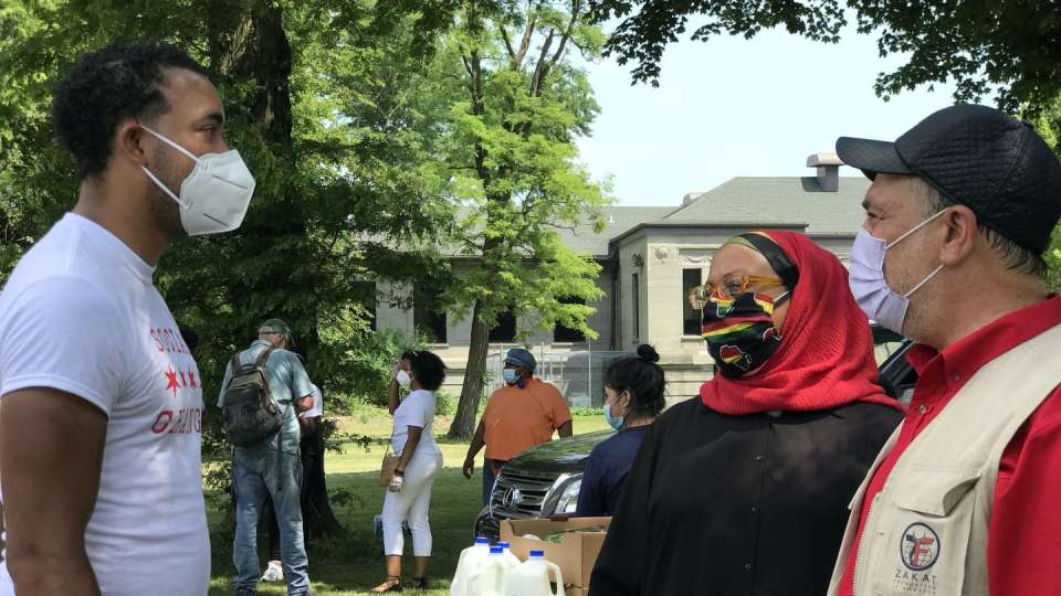 Donna Neil-Demir (center), RN and Zakat Foundation of America’s health advisor has a discussion with Executive Director Halil Demir (right) and a volunteer (left) at a Juneteenth distribution in Chicago in 2020. | Zakat Foundation of America photo