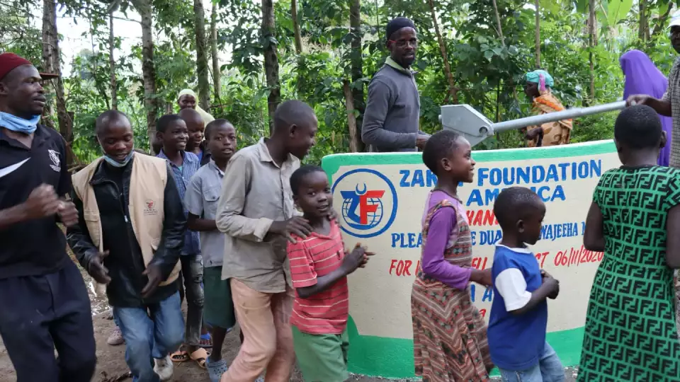 Residents dance around the newly built well in appreciation. – Zakat Foundation of America photo