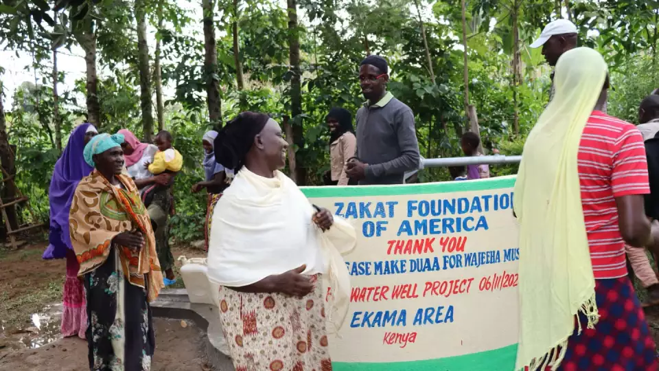 Women dance around the well in celebration. – Zakat Foundation of America photo