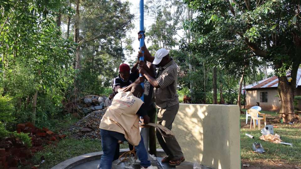 A group is needed to properly install the steel pipe that connects the spout to the water source – Zakat Foundation of America photo