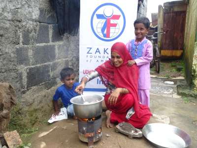 A mom, making dinner for her kids with generous qurbani meat that was donated. | Zakat Foundation of America