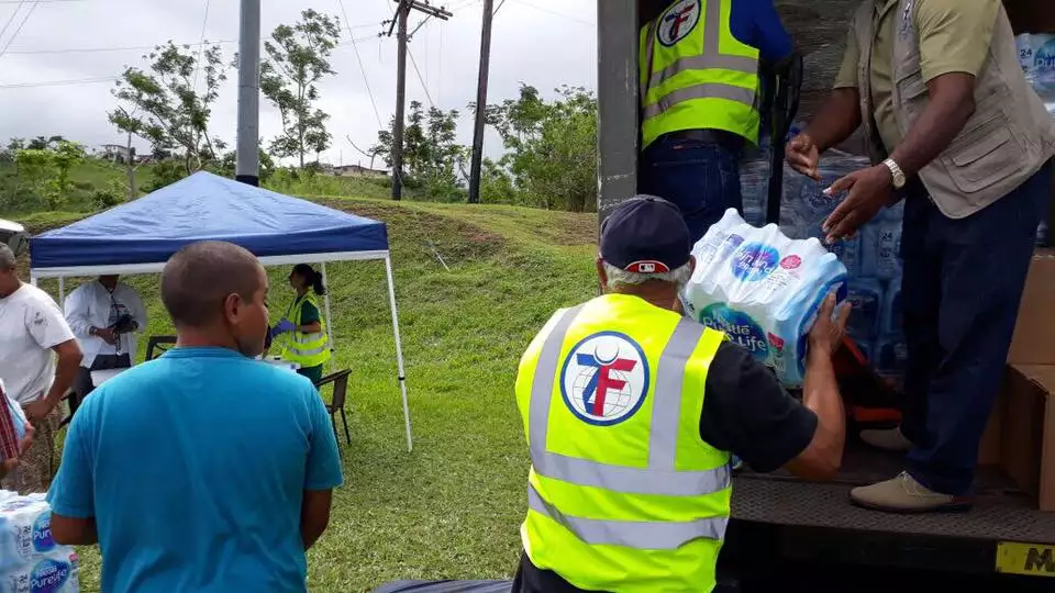 Aid workers distribute fresh water to rural communities in Puerto Rico.