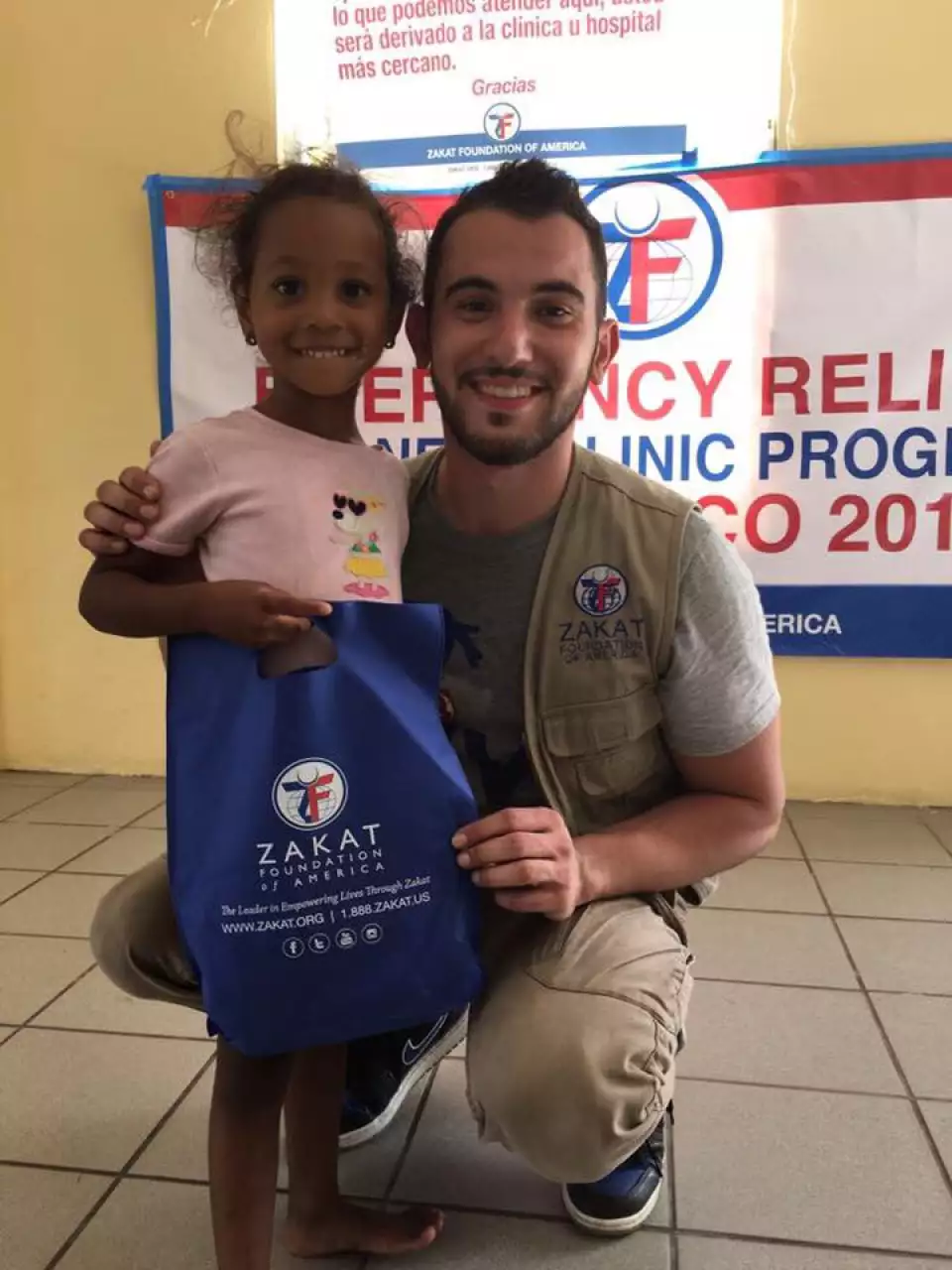 Abdelhamid poses with a young beneficiary on the last day of the trip.