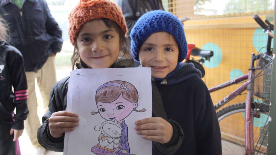 2 girls holding a drawing. Argentina.