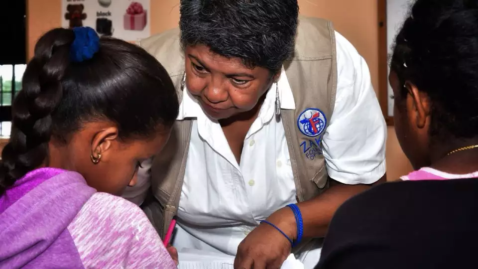 a zakat foundation rep interacts with a young learner