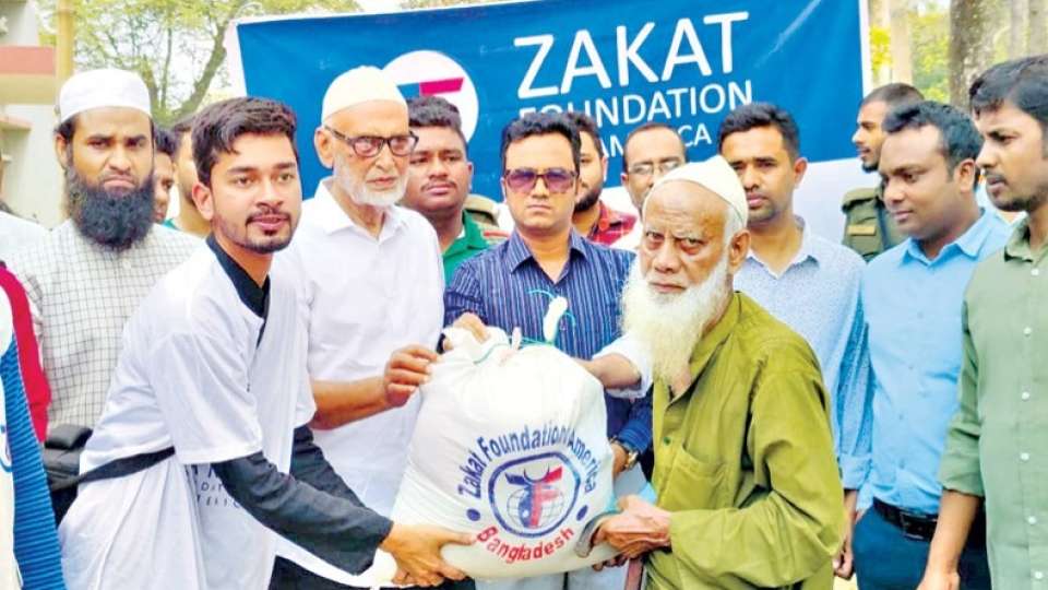 Madan upazila chairman Md Habibur Rahman and UNO Md Shah Alam Mia, among others, distribute food items among poor families donated by Zakat Foundation of America in Madan upazila of Netrakona on Thursday. — Press release