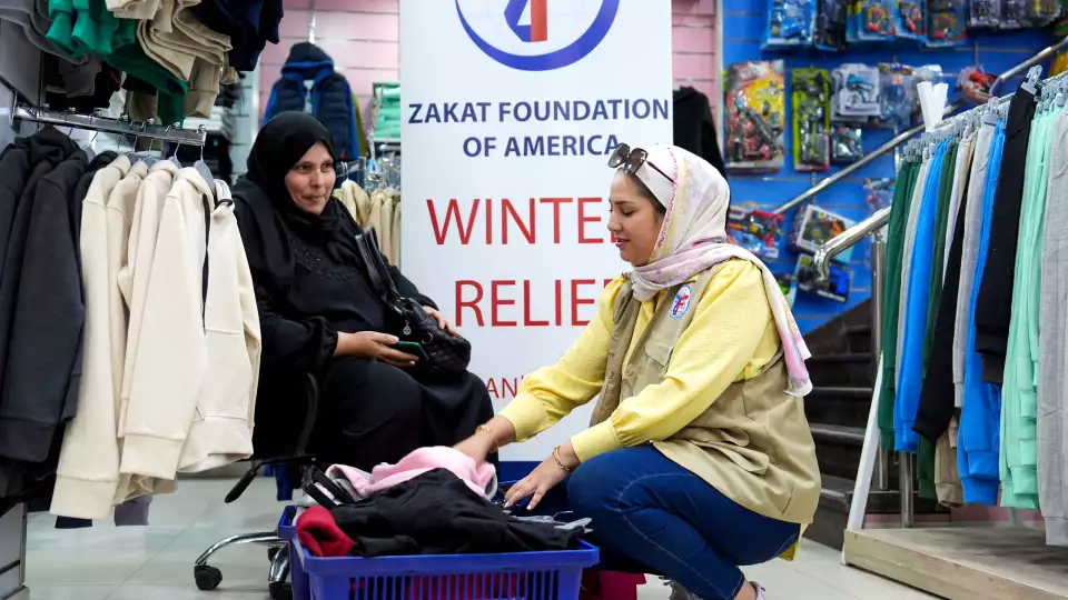 Orphan guardians take a moment to connect with our team while receiving winter items