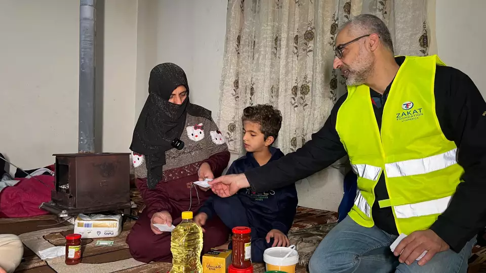 A mother in Lebanon receive winter food staples for her family