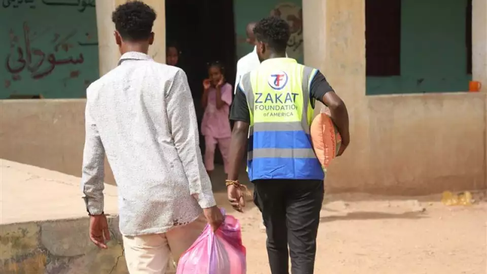 Children in Sudan wait eagerly for their food package as hunger grows