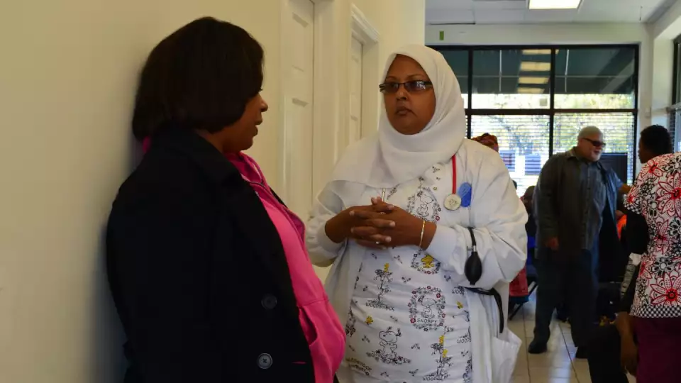 Donna Neil-Demir, RN, Zakat Foundation of America’s health advisor, high-fives a peer at a 2012 Inner-City Muslim Action Network (IMAN) event in Chicago called “Takin’ It to the Streets.” | Zakat Foundation of America photo