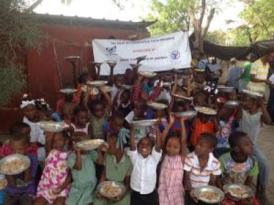 Children in Haiti celebrate a meal provided by Zakat Foundation in partnership with What If?