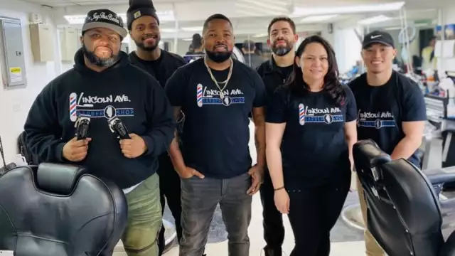 Wilbur Dumas Jr., center, started a barbershop in Elgin with friends wanting to give back to the community. From left are Jimmy Roby, James Jones, Dumas, Daniel Villanueva, Leysha Villanueva and Sam Phonlasouk. - Courtesy of Wilbur Dumas