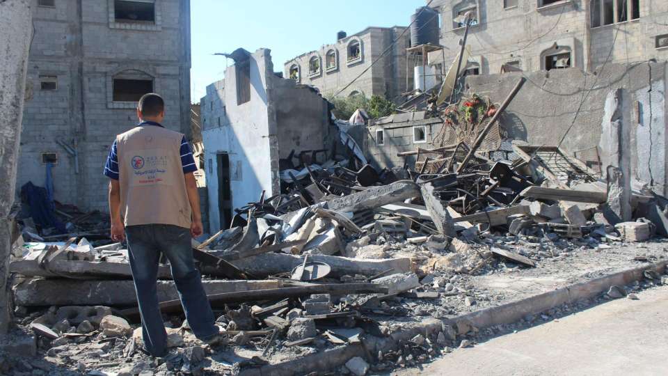 A Zakat Foundation of America representative assesses the rubble in the aftermath of air strikes on Gaza in May 2021. | Zakat Foundation of America photo