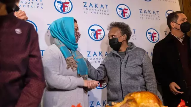 Mayor Lori Lightfoot talking to Afghani Refugee on Thanksgiving Day.