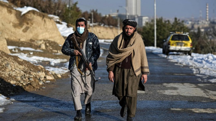 Taliban fighters walk along a road at the Wazir Akbar Khan hill in Kabul on January 10, 2022. (AFP)