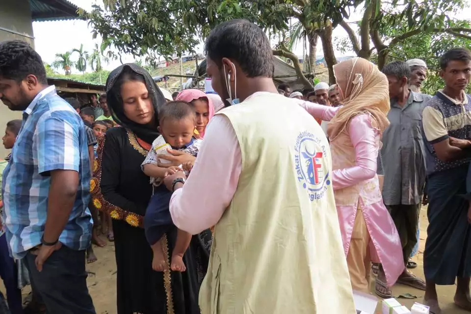Zakat Foundation of America workers provide medical treatment to displaced families arriving to the camp.
