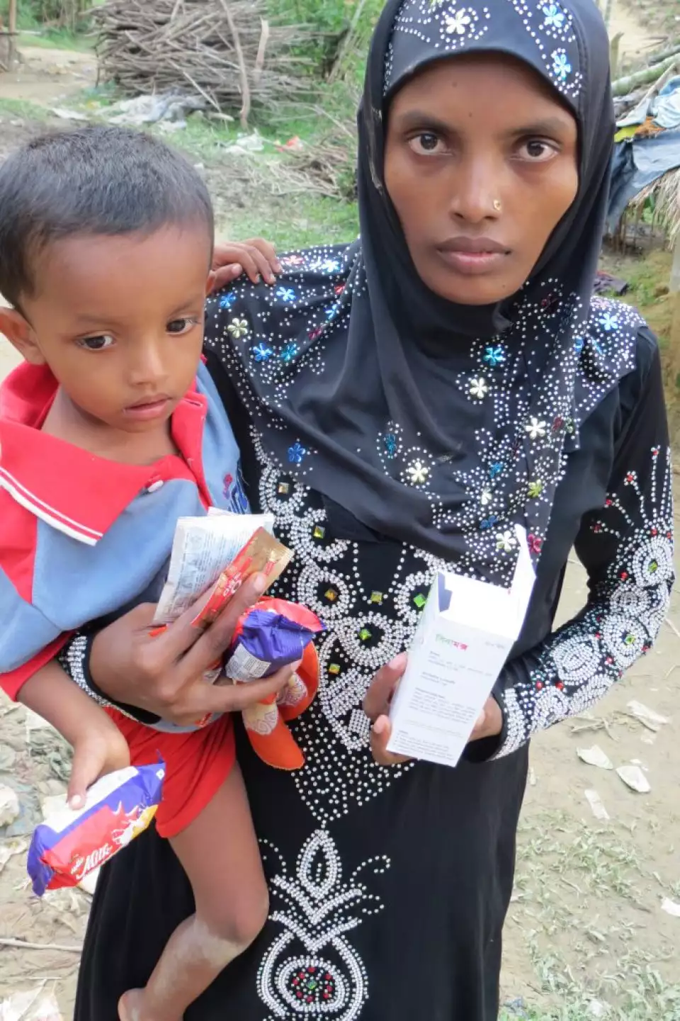 Minara carrying her child.