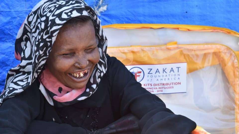 Muslima, a blind Rohingya woman, is delighted to feel the warmth of your winter relief gift