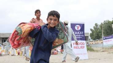 smiling child with flood relief donations
