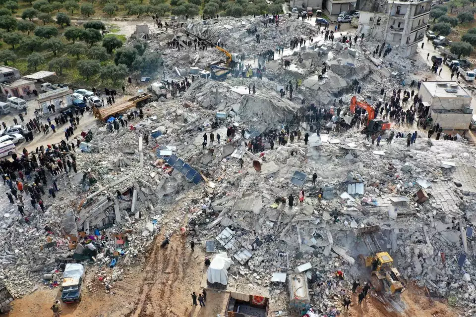 An aerial view shows residents searching for victims and survivors amid the rubble of collapsed buildings on Feb. 6, 2023, following an earthquake in the village of Besnia near the town of Harim, in Syria's rebel-held northwestern Idlib province on the border with Turkey. (Omar Haj Kadour/AFP Getty/AFP via Getty Images)