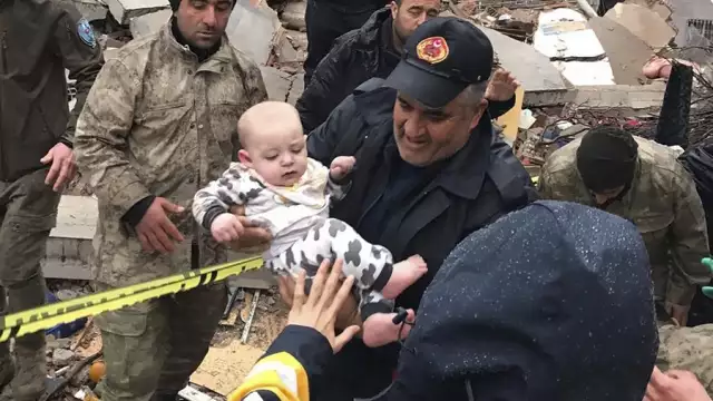 A baby is rescued last week from a building that was destroyed by an earthquake in Malatya, Turkey. DIA Images via AP