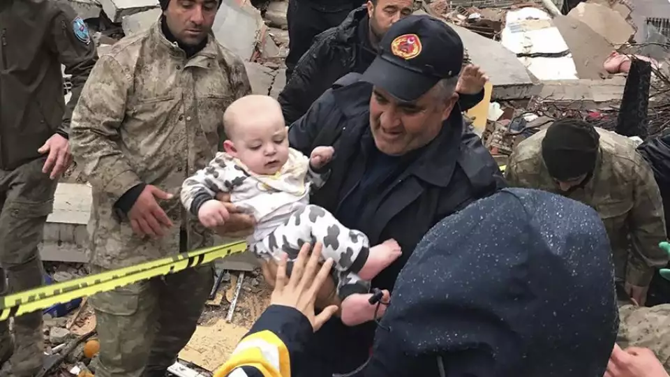 A baby is rescued last week from a building that was destroyed by an earthquake in Malatya, Turkey. DIA Images via AP
