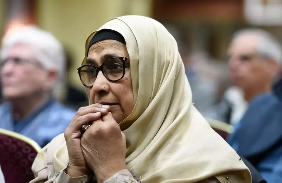 Amna Saeed of Lombard listens Thursday during a vigil in Mount Prospect for those in the earthquake-affected areas of Turkey and Syria. - Rick West | Staff Photographer