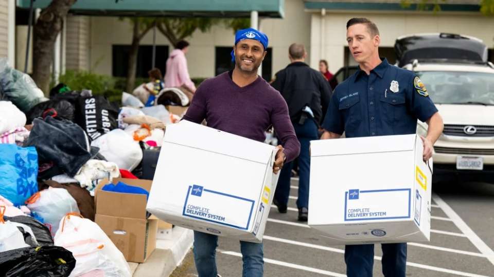 Gagan Johal, left, and OCFA paramedic Jeffery Blake carry boxes of donated items during a coat and blanket drive for the victims of the earthquake in Turkey and Syria at the Lakeview Senior Center in Irvine on Sunday, February 12, 2023. The event was sponsored by the City of Irivne, the Rotary Club of Irvine and Team Kids. (Photo by Leonard Ortiz, Orange County Register/SCNG)
