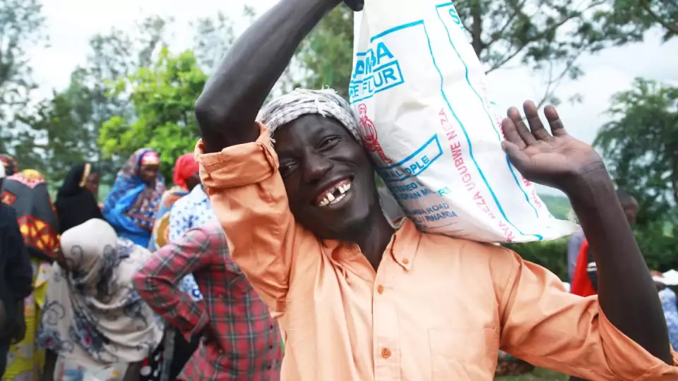 a joyful smile at a food distribution