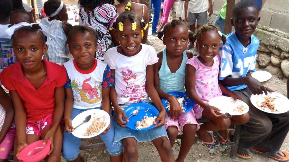 local children enjoy a warm nutritious meal