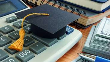 image of calculator money pen little graduation hat on table