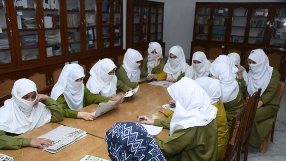 Students at a girls school in India review current events