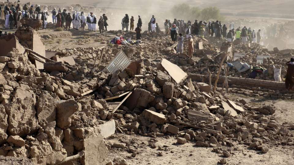 afghanistan earthquake 2023 afghani civilians standing on building rubble