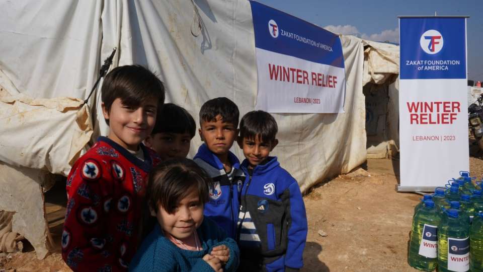 Displaced and refugee children are happy with winter relief / أطفال لاجئون سعداء بتلقيهم الإغاثة الشتوية