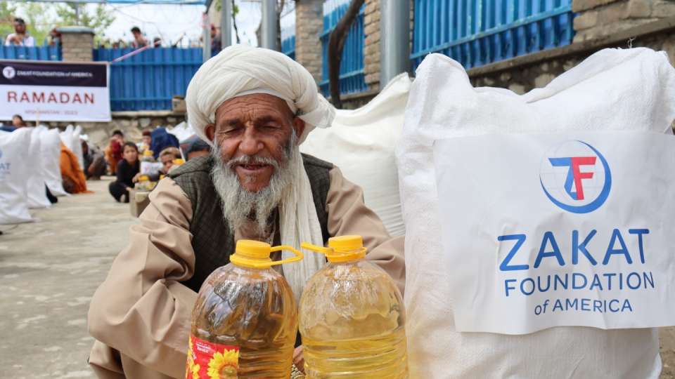 An elderly man in Afghanistan secures his Ramadan package
