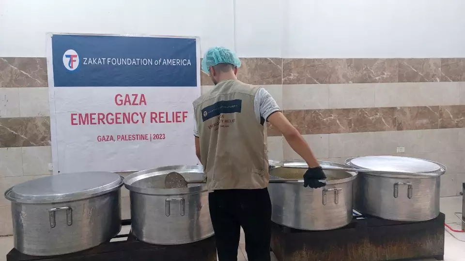 Volunteer works on preparing meals for families