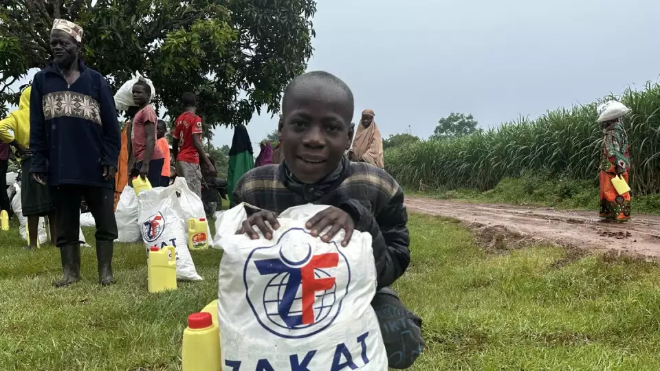 A Ugandan boy receives his food package