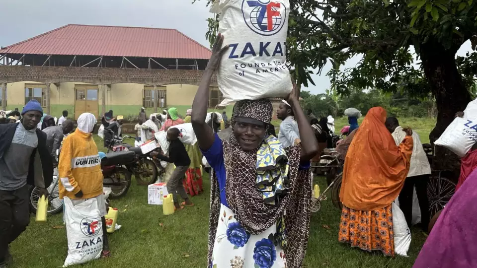A woman in Uganda is headed home with a food package
