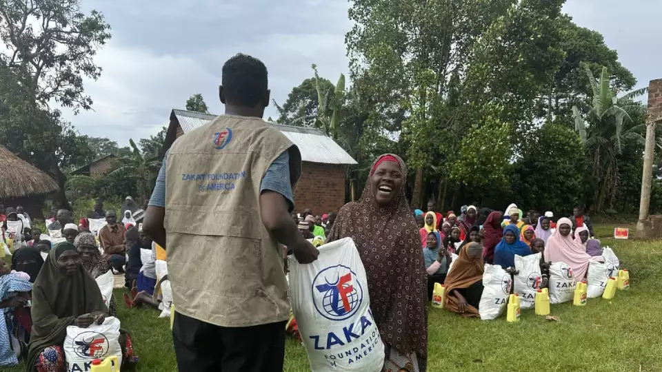 A mother in Uganda is all smiles with your support