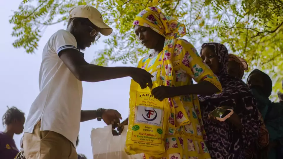 A mother in Senegal receives her Ramadan food package