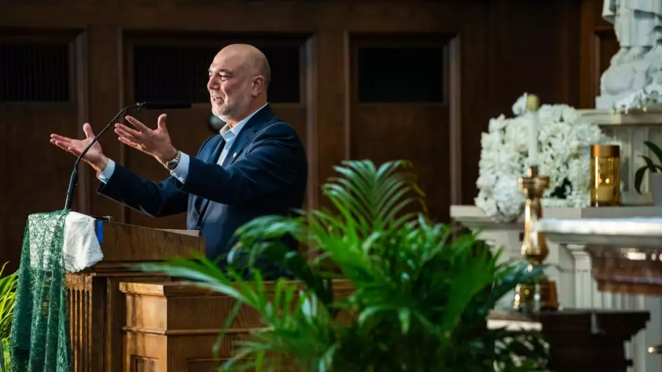 Halil Demir, executive director and founder of Zakak Foundation of America, speaks as migrants were welcomed with a dinner at the recently opened migrant shelter at St. Bartholomew Catholic Church in Portage Park on June 11, 2024. Credit: Colin Boyle/Block Club Chicago