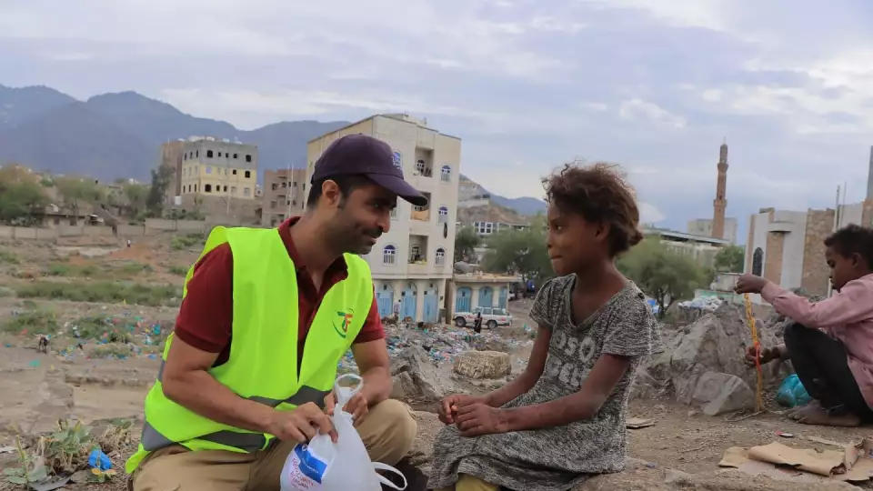 A ZFA worker chats with a young Yemeni girl in her community