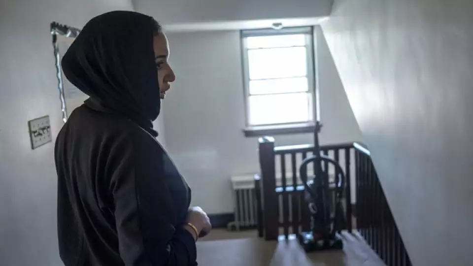 Amina Demir, chief operating officer of Zakat Foundation of America, walks through the migrant family housing shelter at the former St. Bartholomew school and convent in Chicago. © Joel Angel Juarez for The Washington Post
