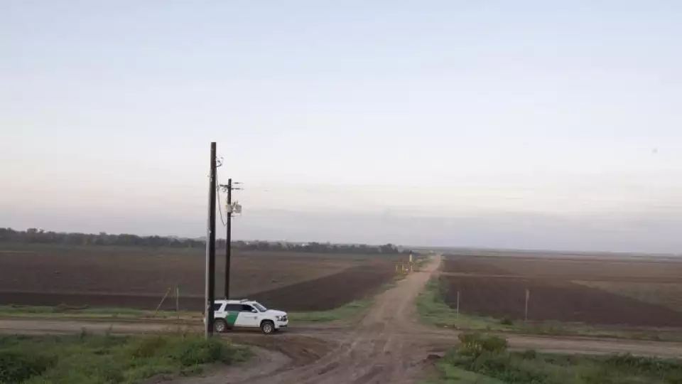 A U.S. Customs and Border Protection vehicle is stopped on a farm road on Tuesday outside McAllen, Texas, near the U.S.-Mexico border. © Kirsten Luce for The Washington Post